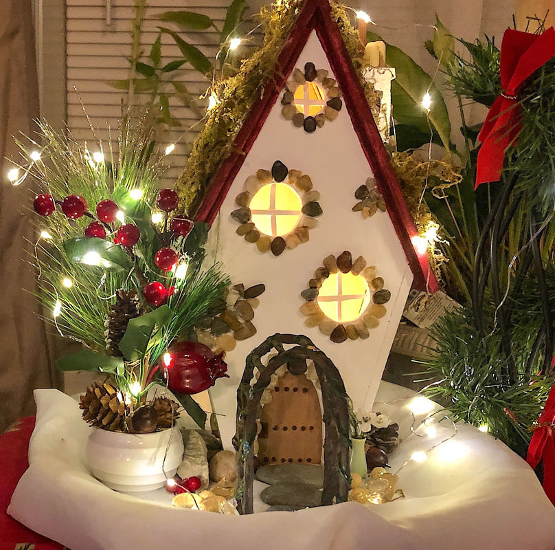 Christmas themed handcrafted fairy house and garden.