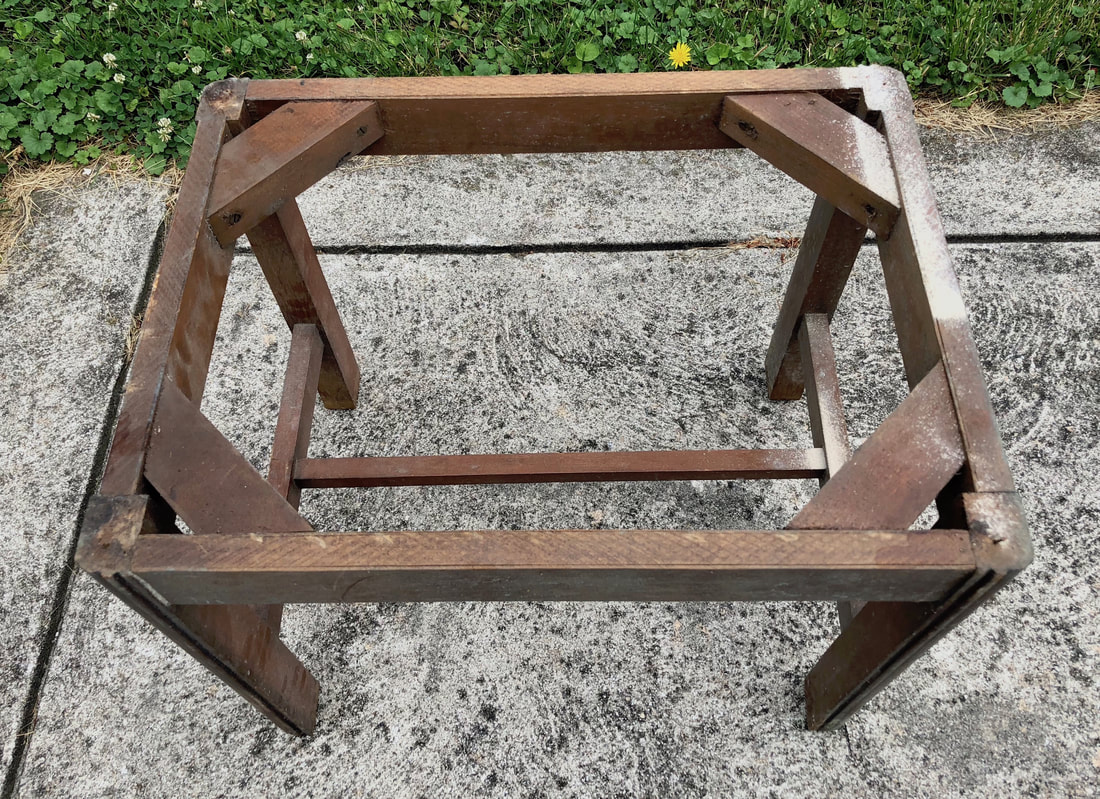 Wood frame of a thrifted vintage foot stool.