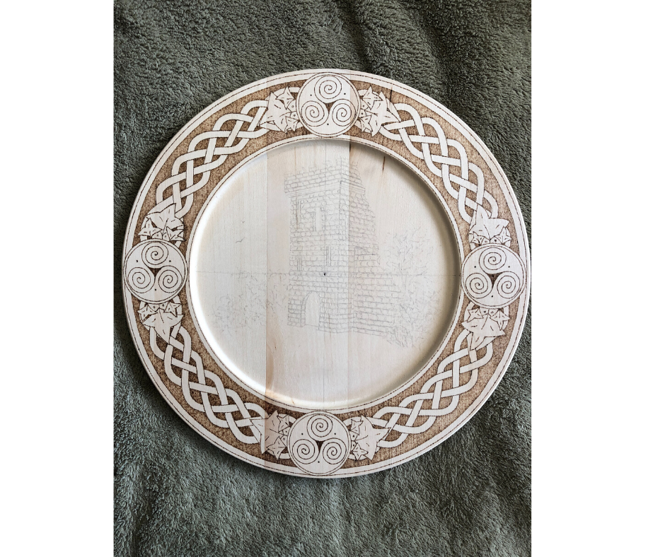 Celtic themed decorative plate with a hand drawn wood burned design and castle in progress
