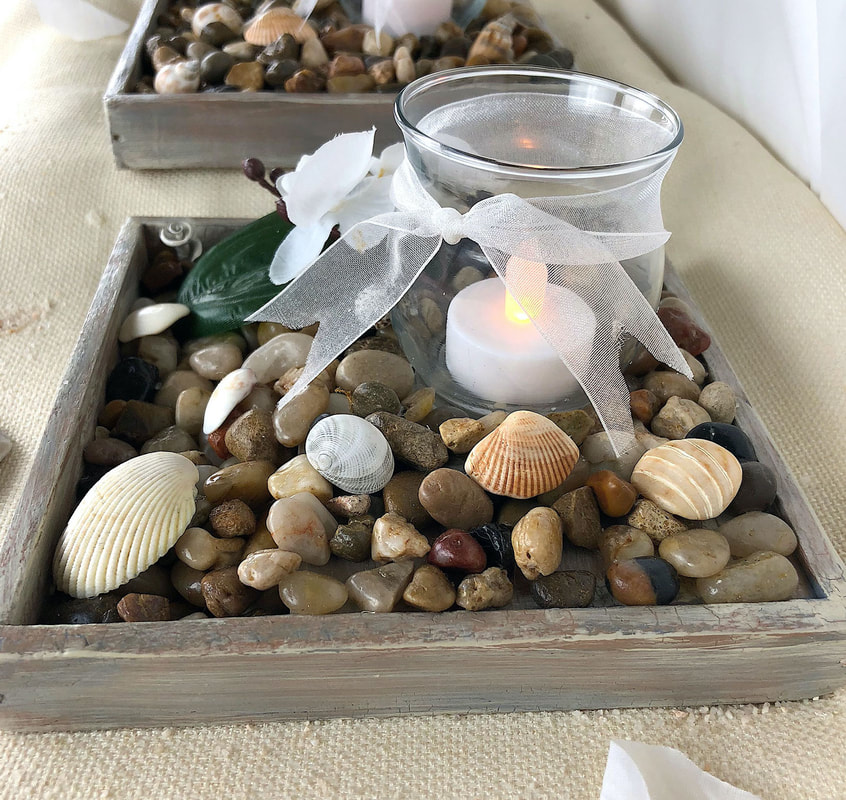 Handcrafted seashore theme candleholder with shells.
