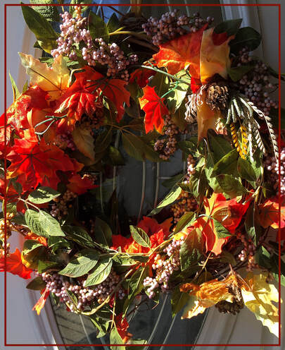 fall wreath hanging on a door