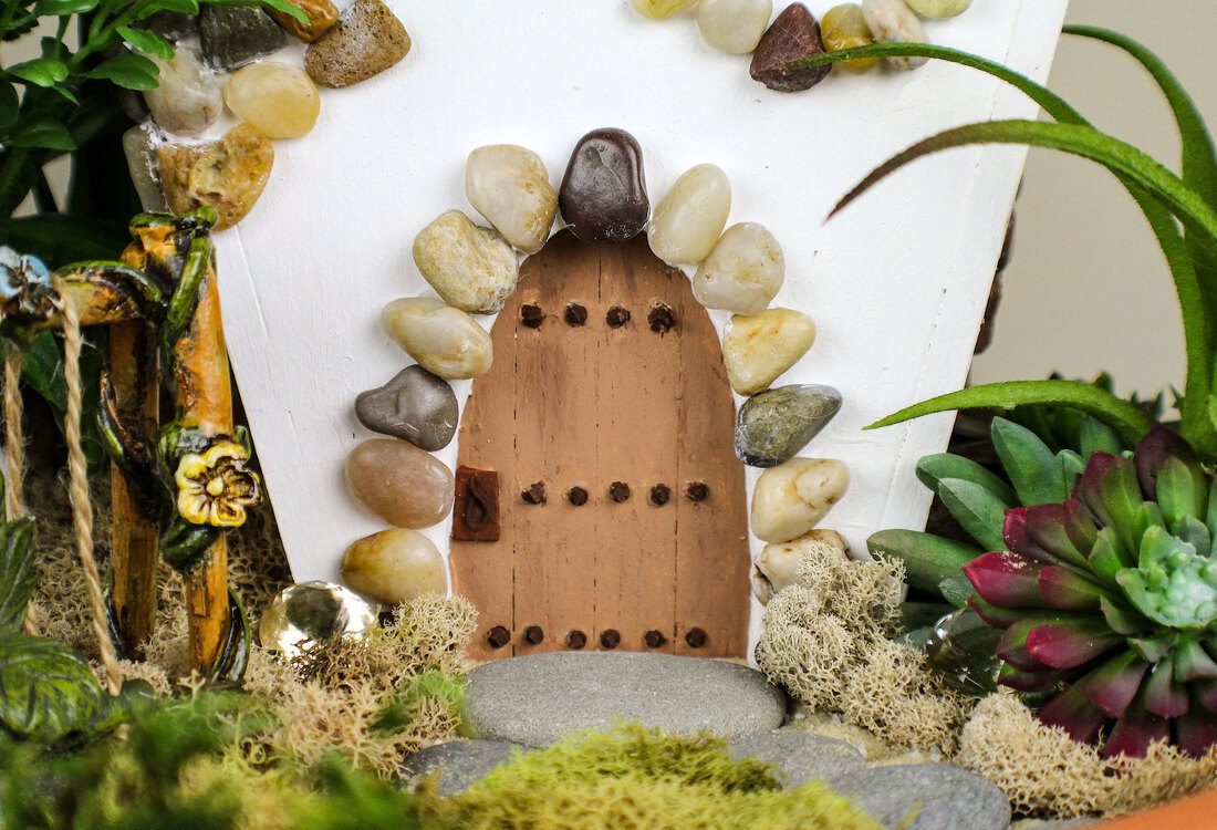 Closeup of a fairy house and garden by Di's Studio Designs.