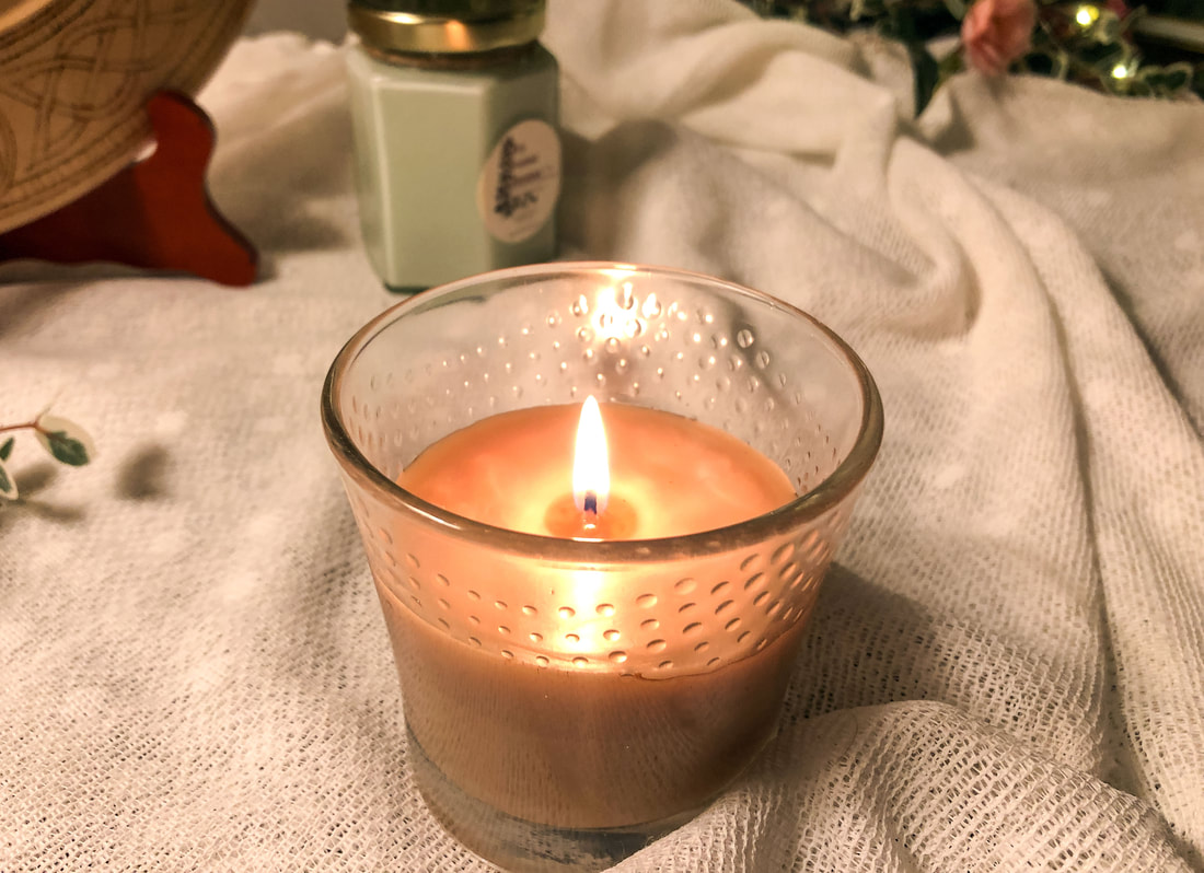 Candle burning provides a warm hygge glow in a space.