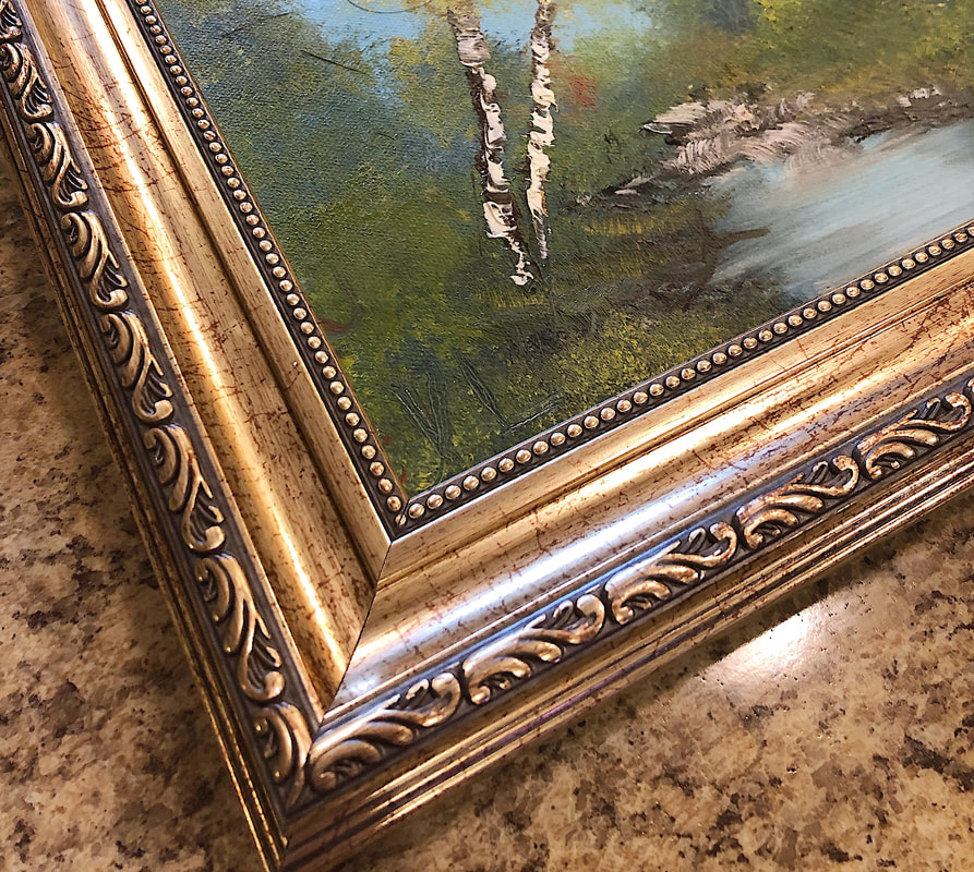 Hand painted artwork in a decorative gold frame.