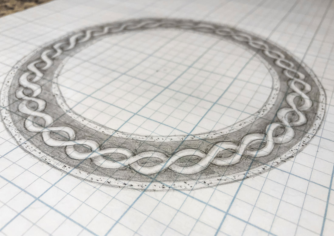 Circular border knot drawing on grid paper.