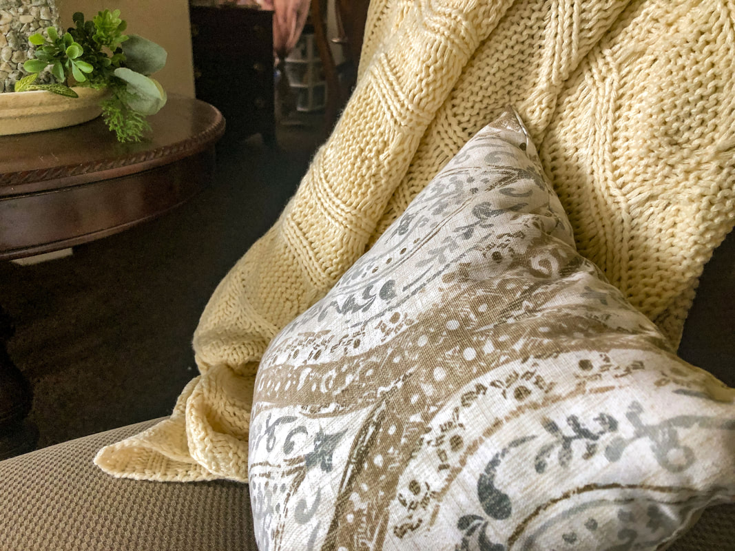 Throw pillows and blankets add cozy texture to winter home decor.