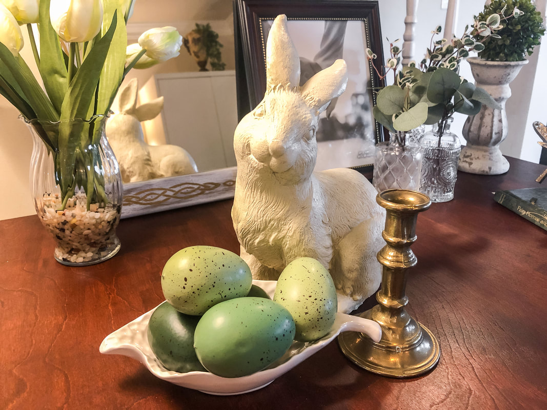 Spring vignette with white bunny and pastel green eggs.