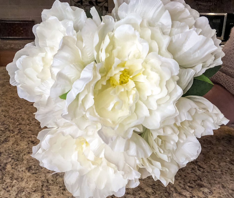 White faux florals in a bouquet arrangement.