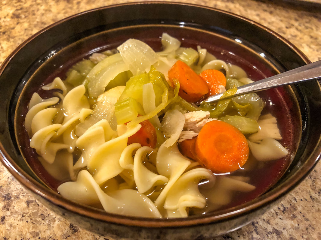 Homemade chicken soup in a bowl.