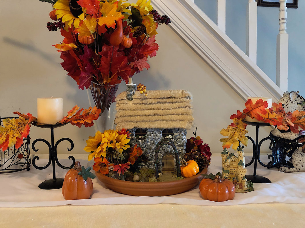 Autumn themed indoor fairy garden with handcrafted English Cottage.