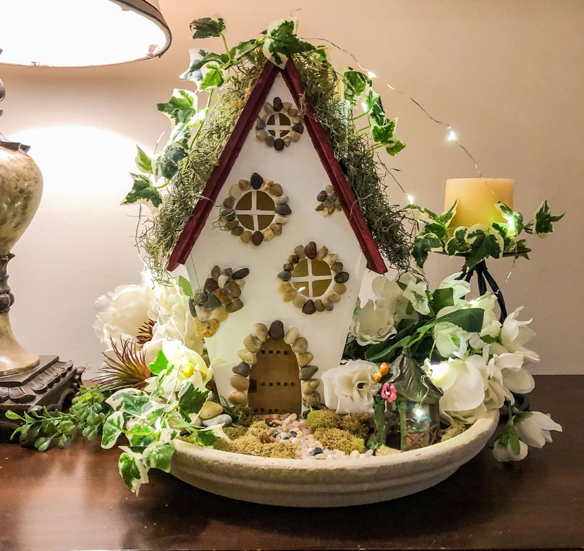Fairy Cottage with white faux florals and fairy lights.