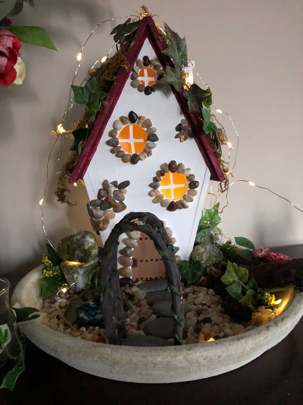 Handcrafted fairy cottage and indoor fairy garden with LED lights.