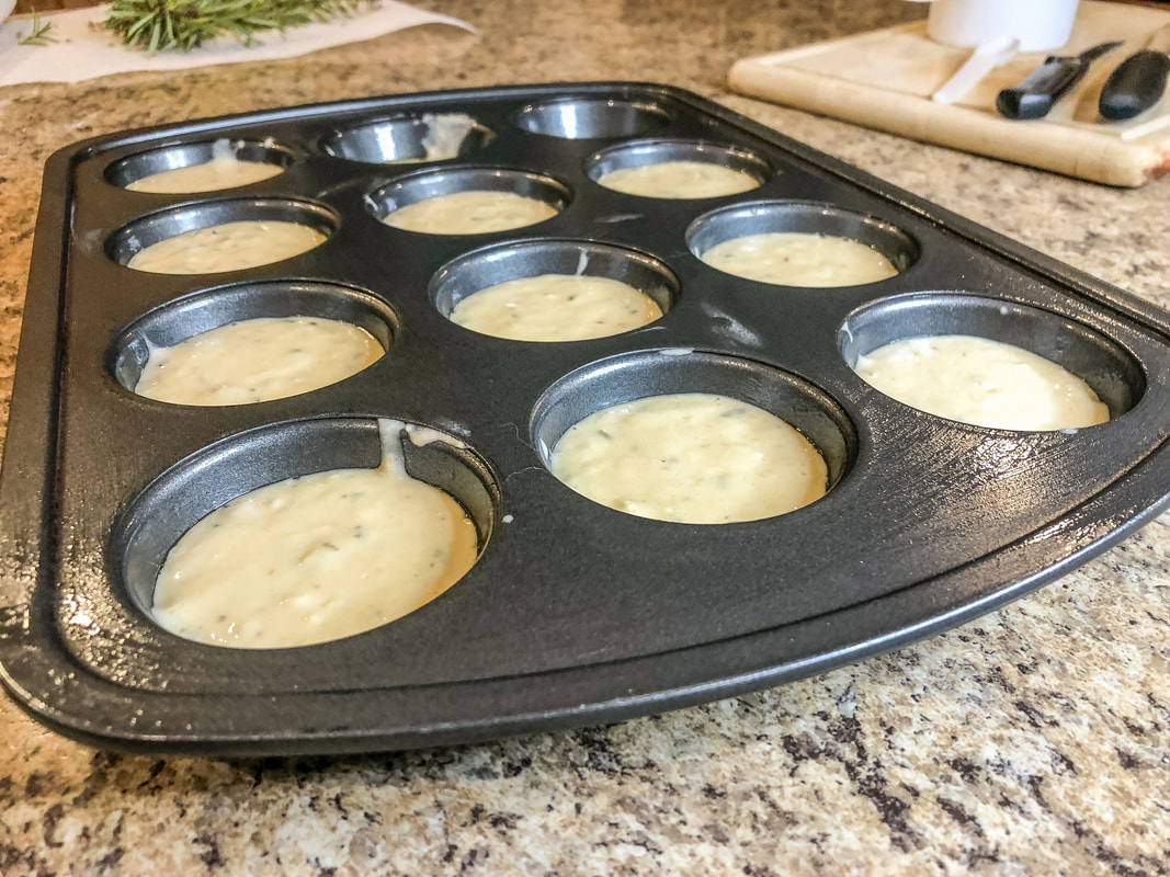 Muffin tray filled with batter ready for oven.