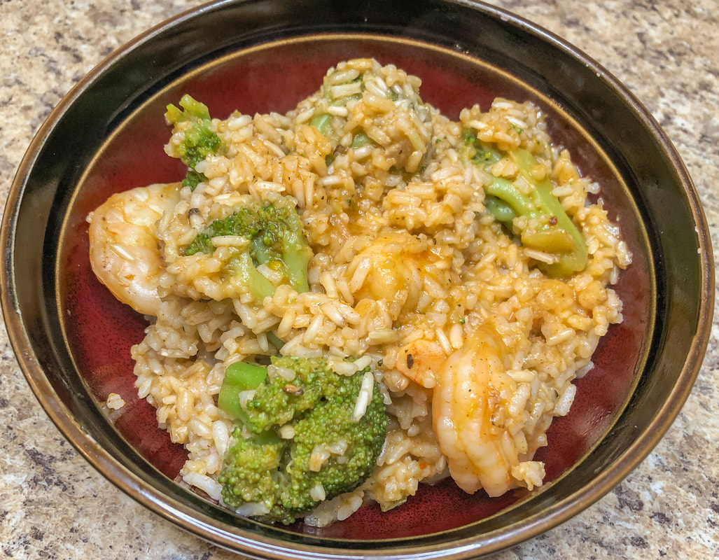 Spicy shrimp and broccoli with rice in a bowl.
