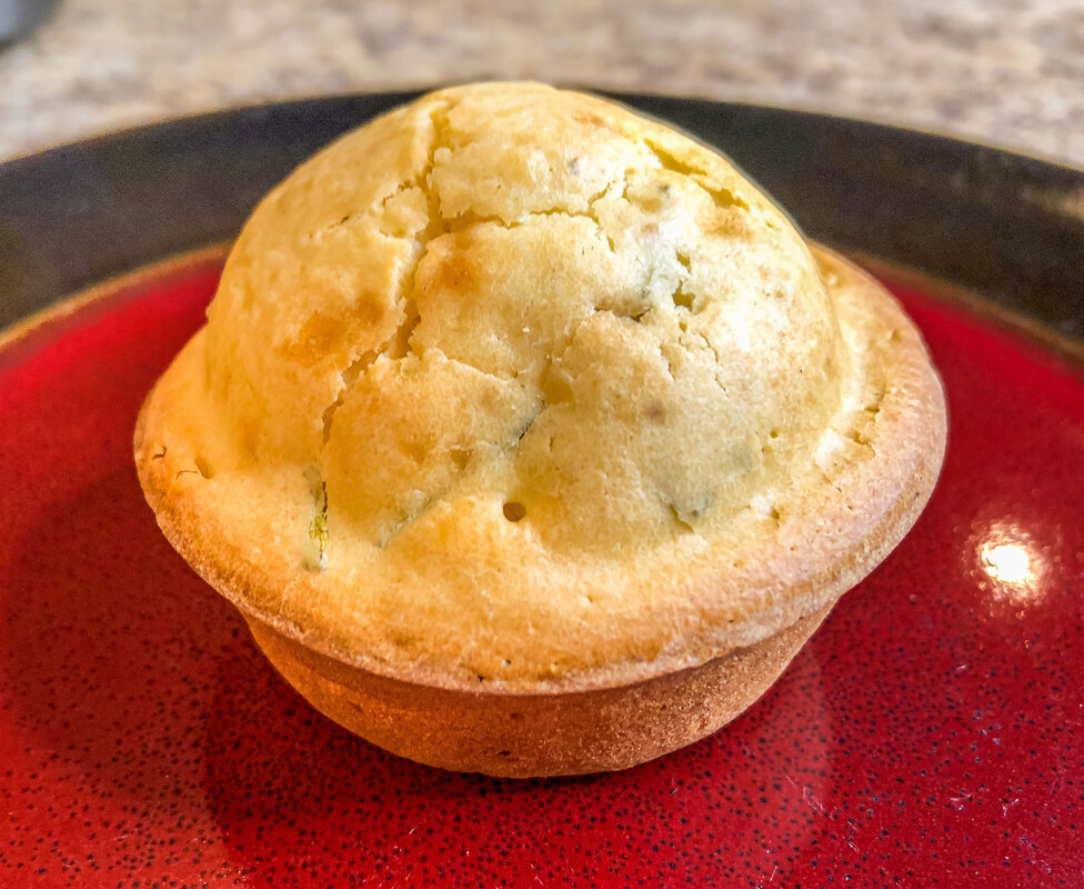 Freshly baked muffin on a plate.