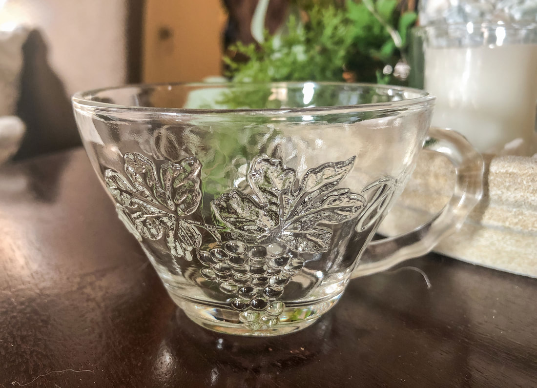 Glass tea cup with grape design from a thrift store.