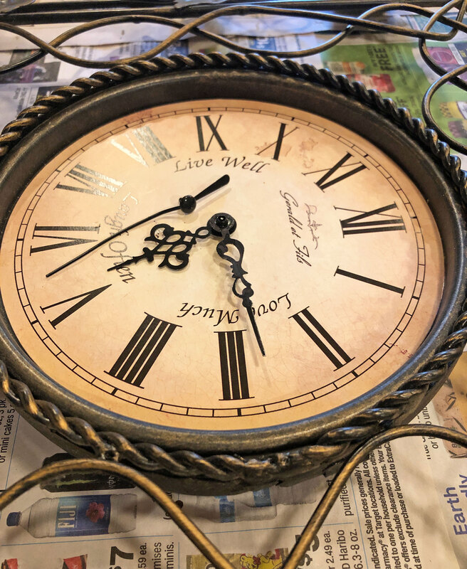 Removing clock hands from a thrifted clock for a DIY project.