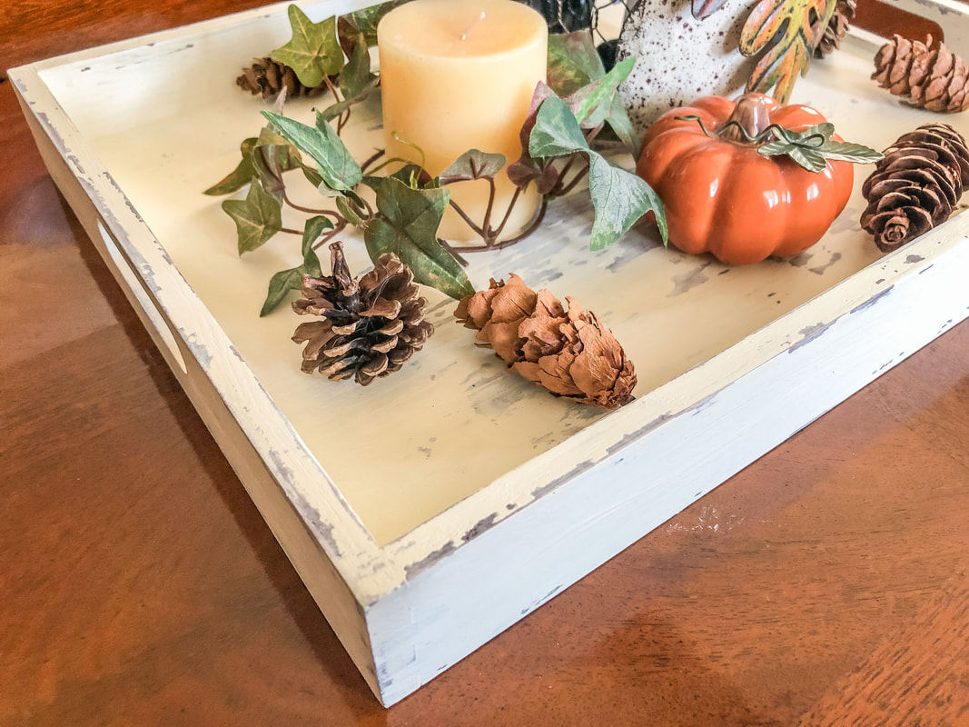 Fall decor on decorative tray with weathered paint.