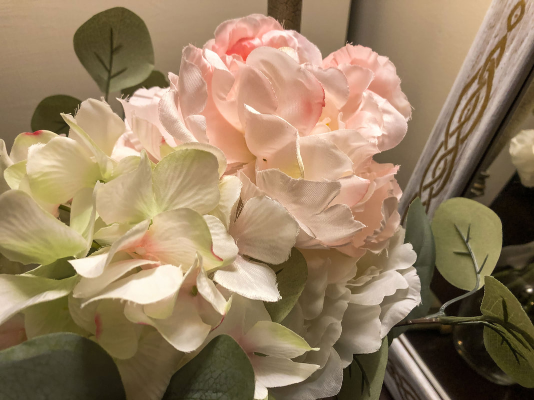 Pink and white faux hydrangea flowers.