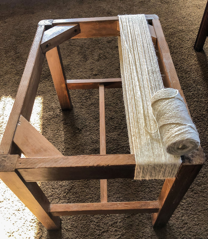 In progress image of DIY wrapping a repurposed stool with jute twine.