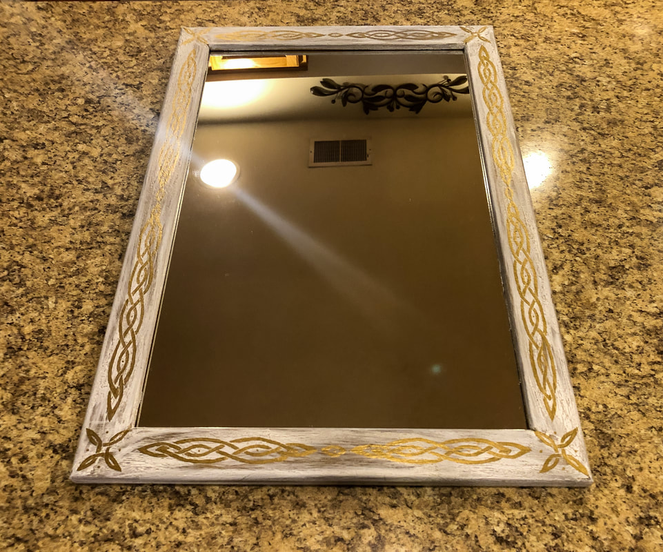 A thrifted mirror with a hand painted Celtic Knot. 
