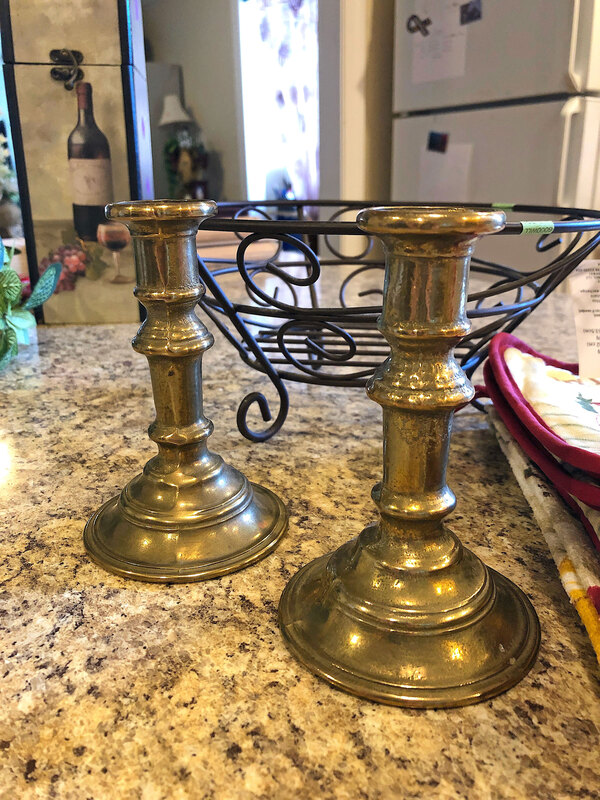 Thrifted metal stick candleholders and wire framed basket.