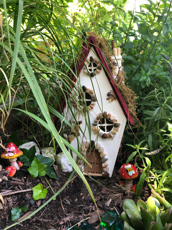 Handcrafted fairy cottage in an outdoor fairy garden