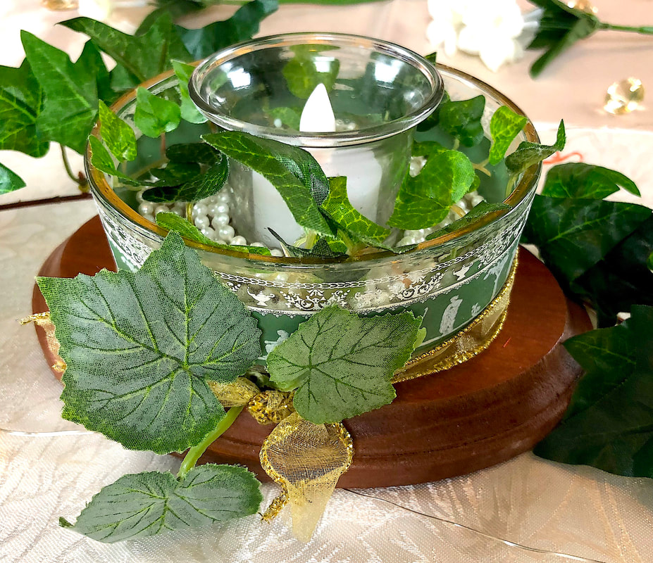 Repurposed Greek style candy dish with faux leaves and vines.