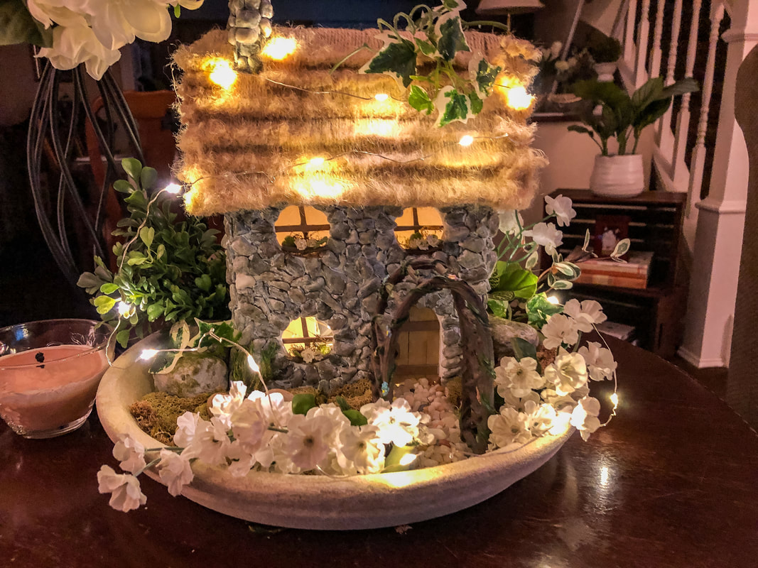 Handcrafted English Cottage and indoor fairy garden with faux florals for spring.