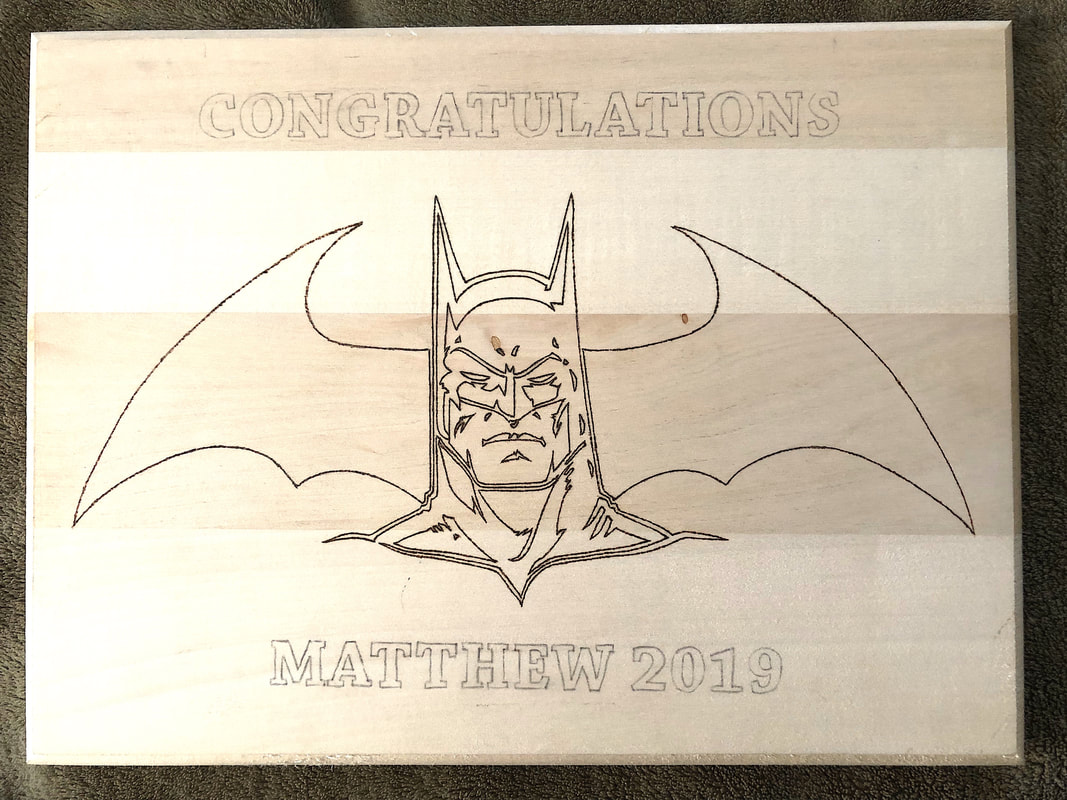 A customized wood burned plaque with Batman in progress