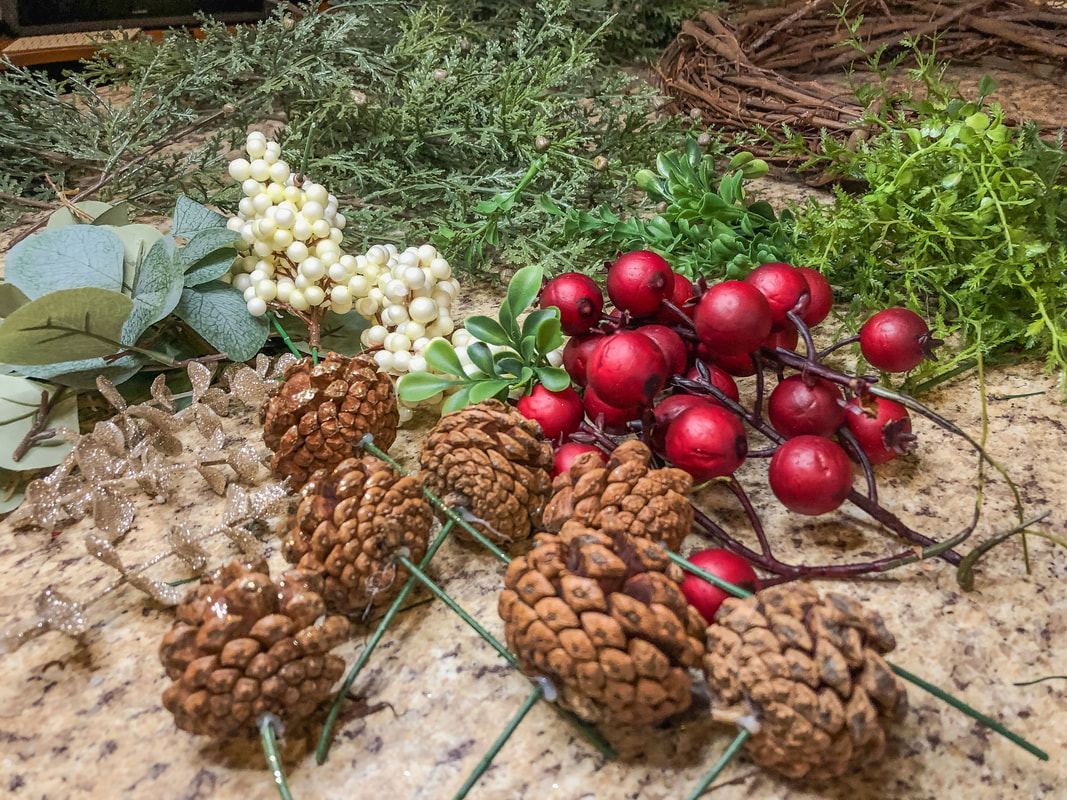 Pinecones, faux berries, and faux greenery for DIY wreath.