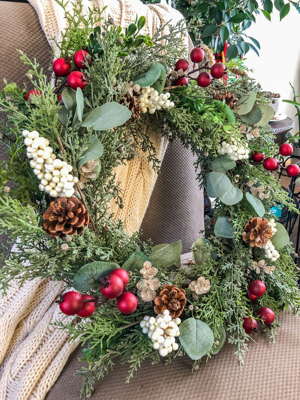 DIY  front door wreath with faux juniper, eucalyptus, and berries.