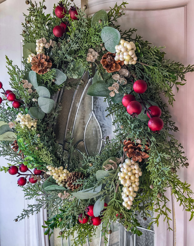 DIY holiday wreath hanging on front door.