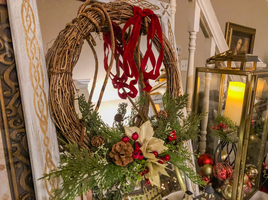 Rustic DIY grapevine holiday wreath on a mirror.