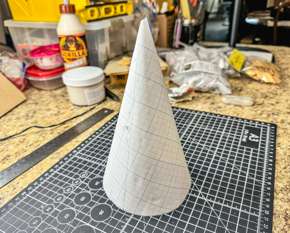 Paper cutout cone made from grid paper.