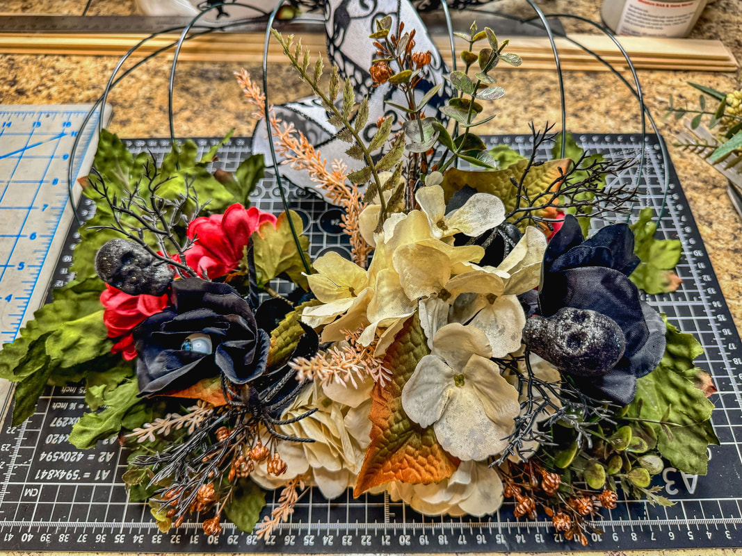 Red, cream, and black faux florals on a pumpkin wireframe 