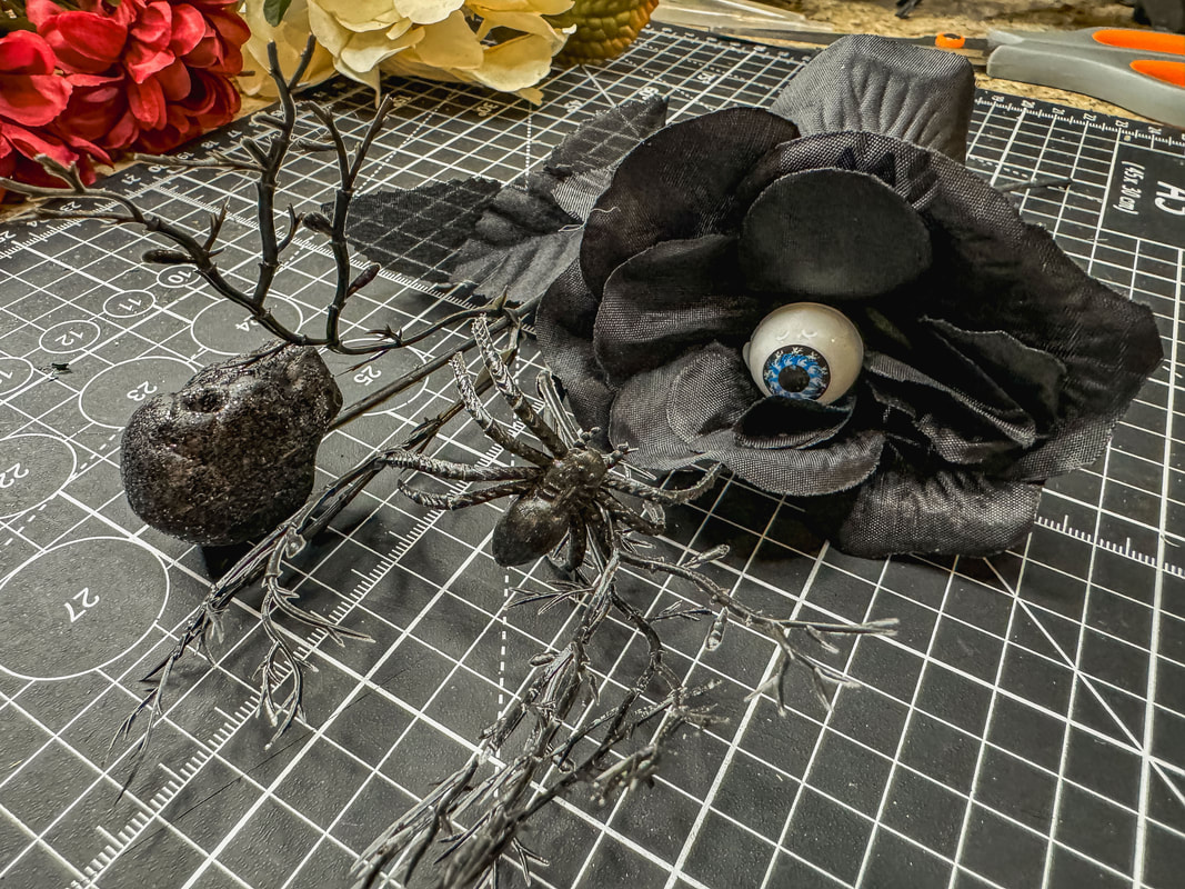 Black eyeballs flower with skull and spider