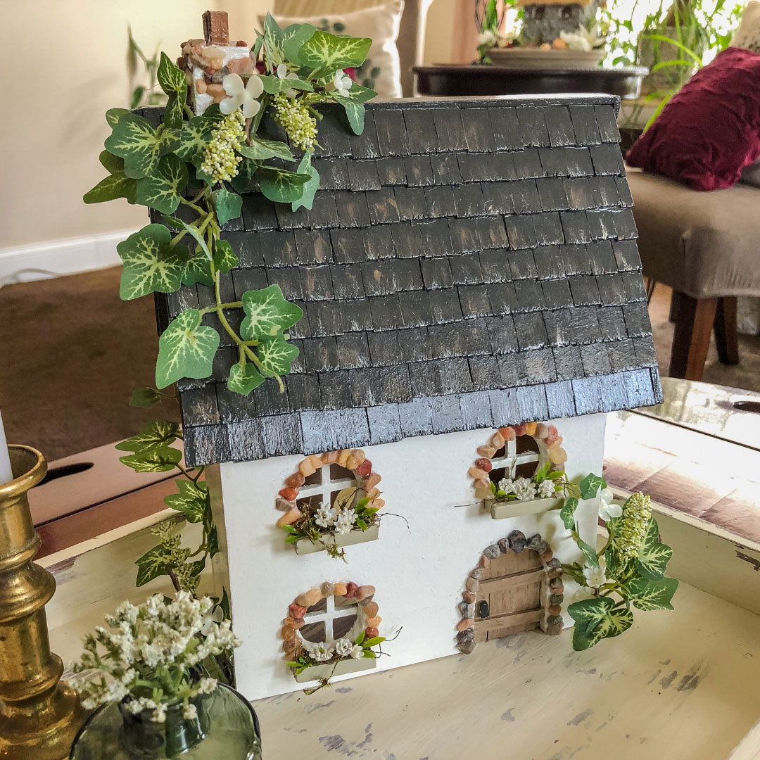 Handcrafted wooden fairy cottage with faux ivy.