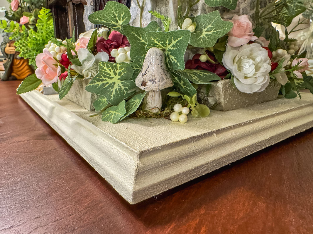 Handmade miniature clay mushroom glued to a faux floral display.
