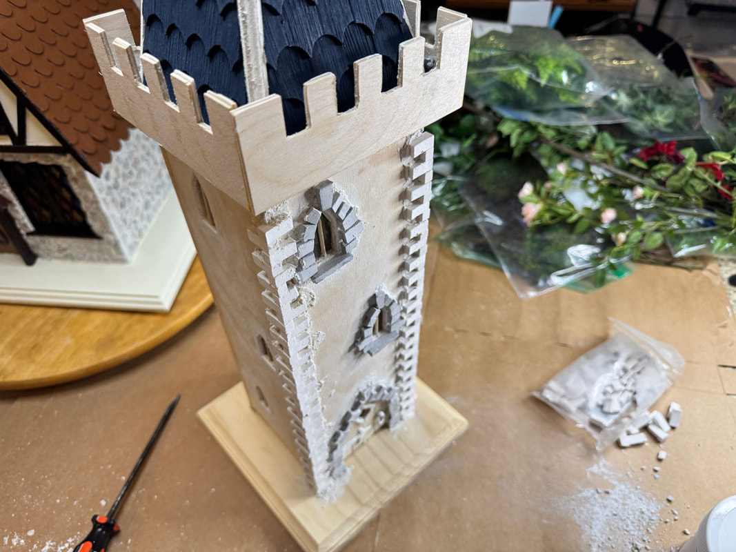 Work in progress setting stonework on a handmade miniature castle.
