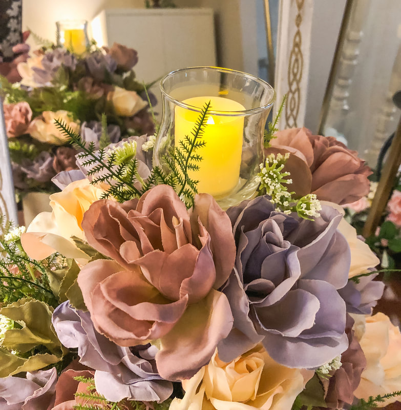 Candle holder with pastel faux roses.