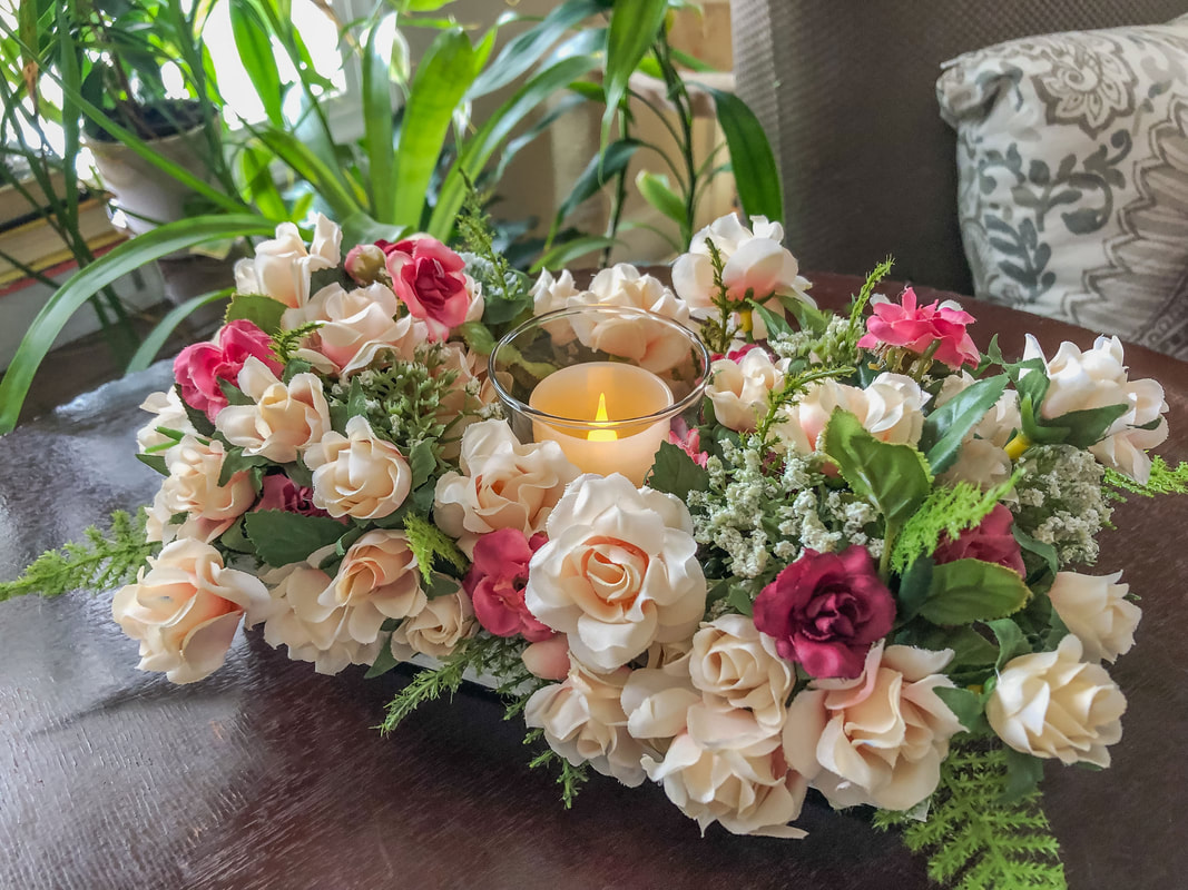 Handcrafted candle holder with miniature faux roses.