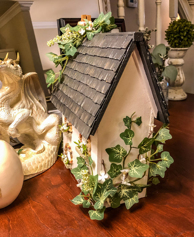 Handcrafted wooden miniature English cottage with faux ivy.