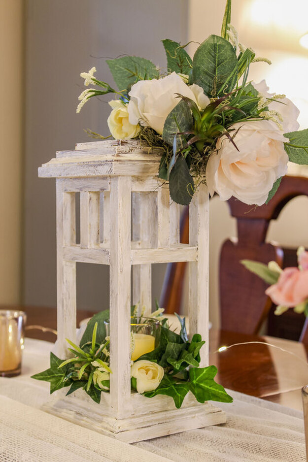 Handcrafted wood lantern candle holder with faux florals.